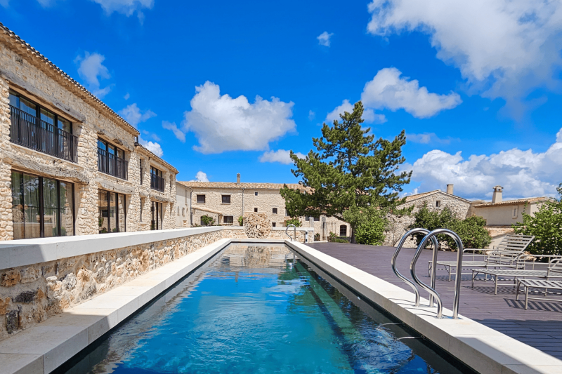 Vue sur la piscine et la cour intérieure du Domaine Château du Bois